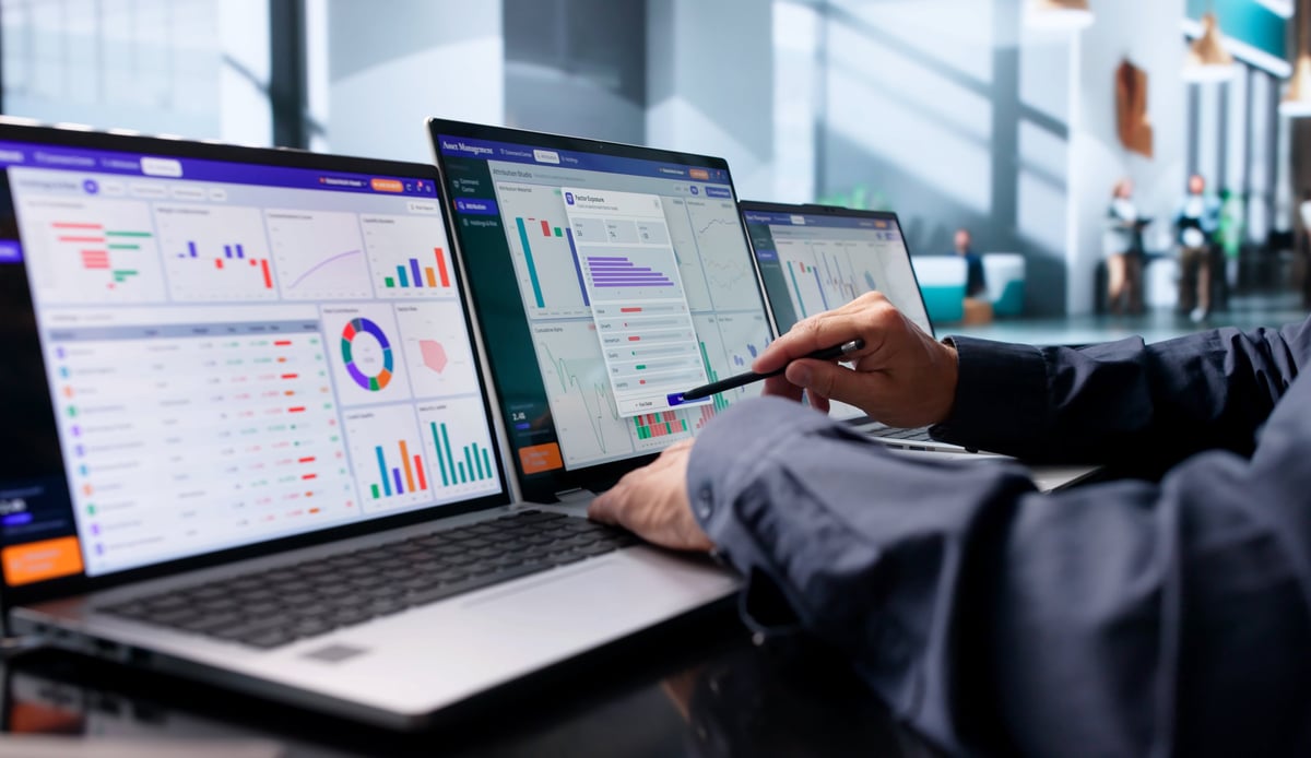 Wealth Advisor Studies Portfolio Data On Laptop, Planning Client Investments Carefully.